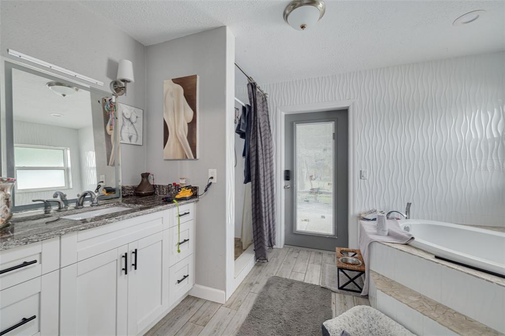 1868 Overview Drive New Port Richey, FL 34655 - Photo 37 of 69 a spacious bathroom with a double vanity sink a mirror and a shower