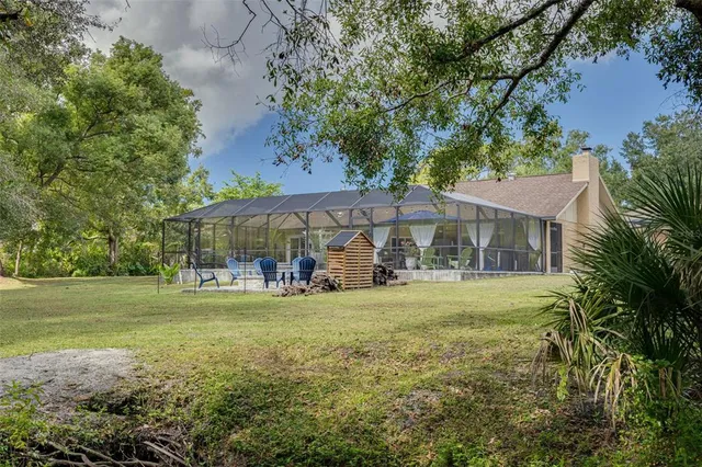 a view of a house with a backyard