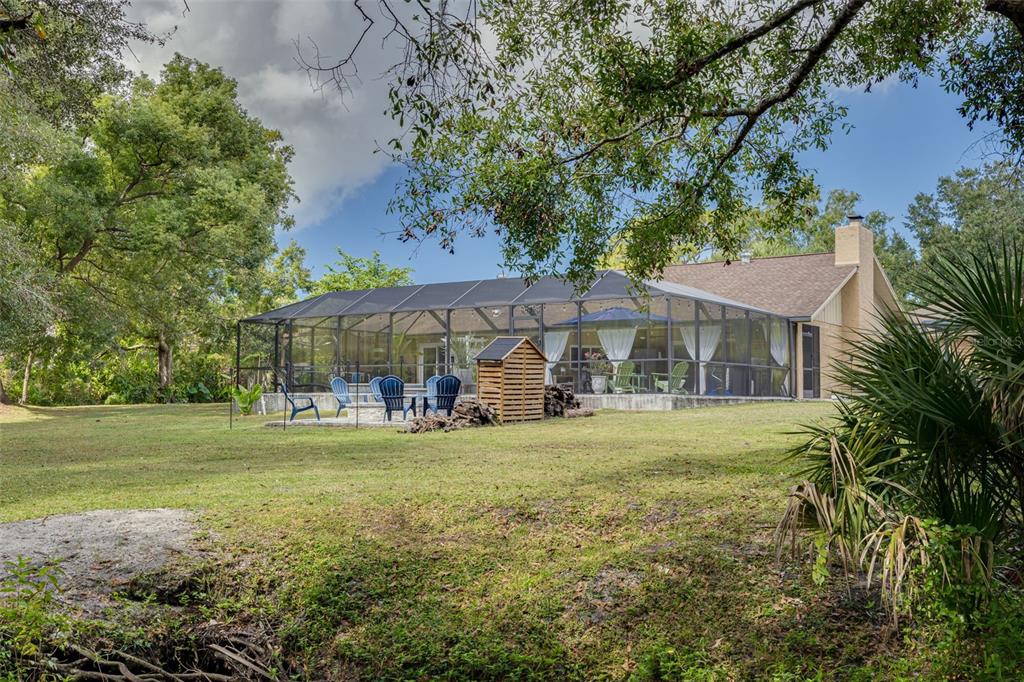1868 Overview Drive New Port Richey, FL 34655 - Photo 48 of 69 a view of a big house with a big yard and large trees