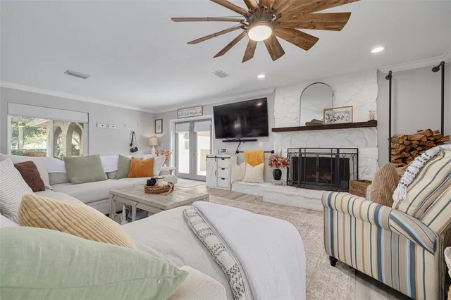 a living room with furniture a fireplace and a flat screen tv