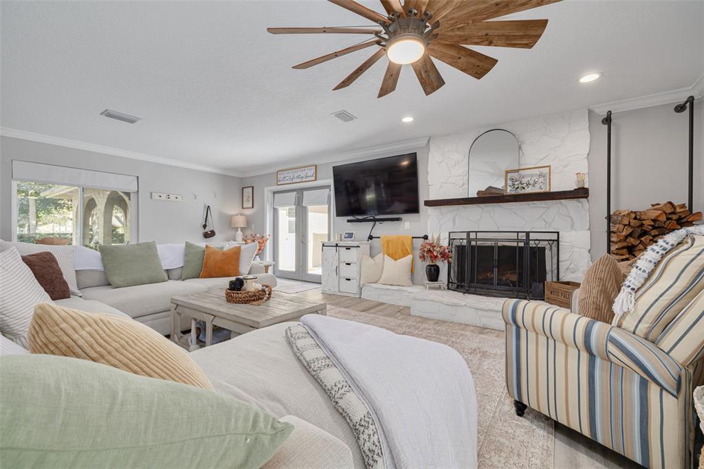 1868 Overview Drive New Port Richey, FL 34655 - Photo 6 of 69 a living room with furniture a fireplace and a flat screen tv