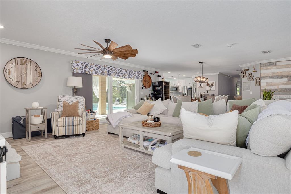 1868 Overview Drive New Port Richey, FL 34655 - Photo 7 of 69 a living room with furniture a table and a large window