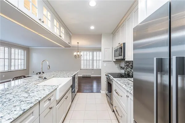 a kitchen with a sink refrigerator and microwave