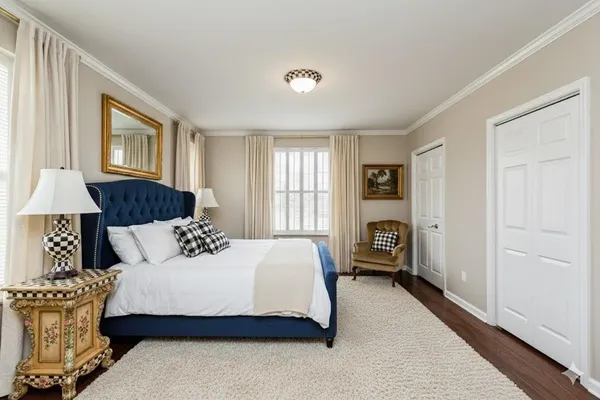 a bedroom with a large bed and a window