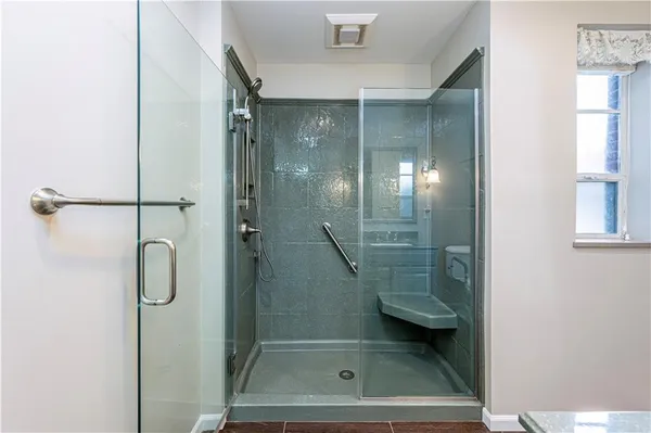 a bathroom with a glass shower door