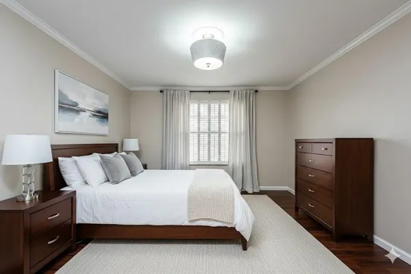 a bedroom with a bed and a lamp