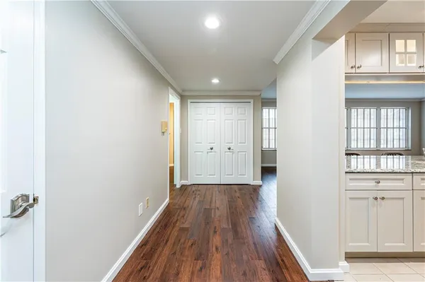 a view of a hallway with wooden floor and a window