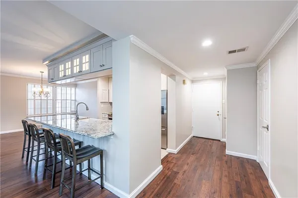 a dining room with furniture and wooden floor