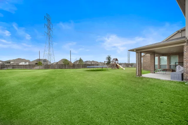 a view of yard with patio