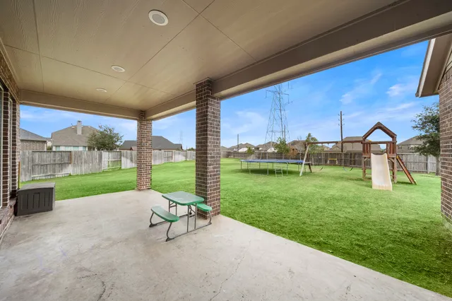 a view of a house with a backyard porch and sitting area