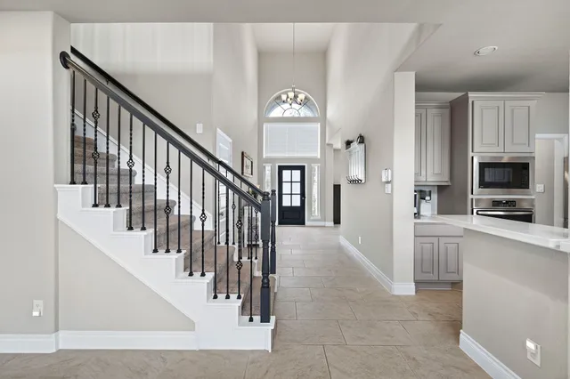 a view of a hallway view with wooden floor and staircase