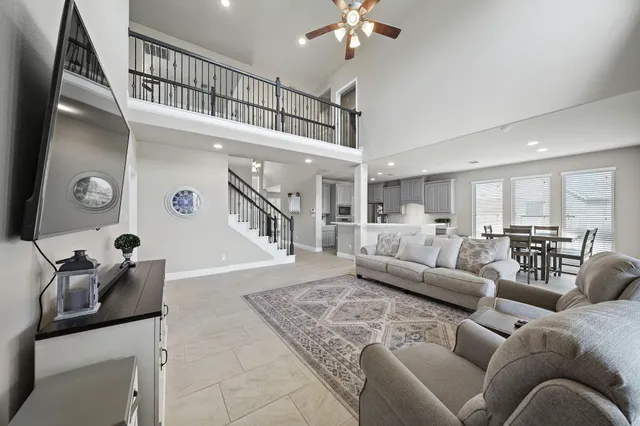 a living room with furniture and a chandelier