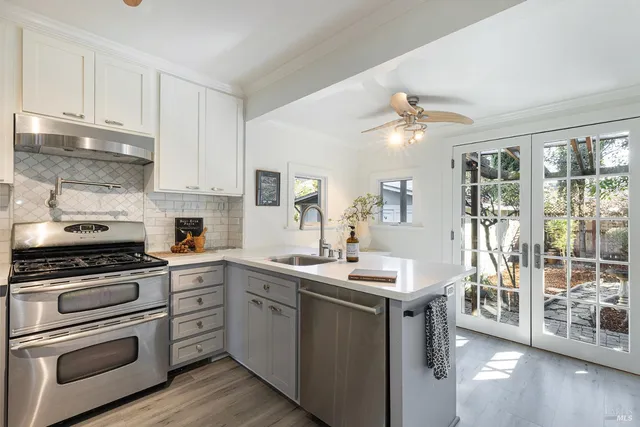 a kitchen with a sink stove and cabinets