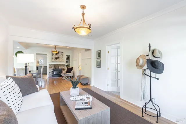 a living room with furniture and a chandelier