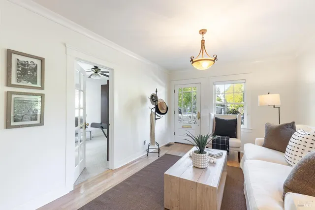 a living room with furniture a chandelier and a window