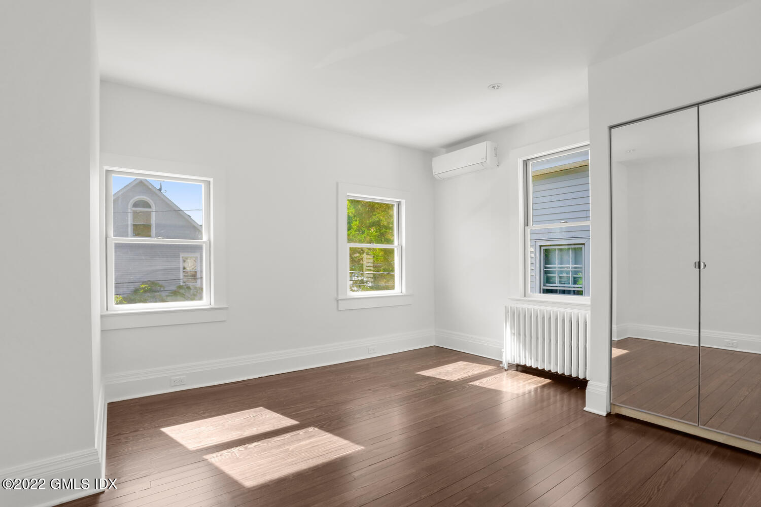 19 Division Street Greenwich, CT 06830 - Photo 5 of 16 a view of an empty room with wooden floor and a window
