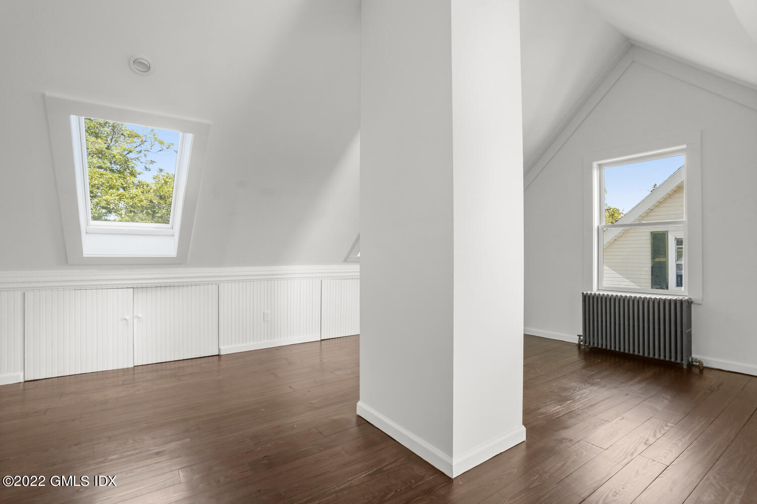 19 Division Street Greenwich, CT 06830 - Photo 7 of 16 a view of an empty room with wooden floor and a window
