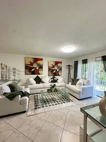 a living room with furniture and a rug