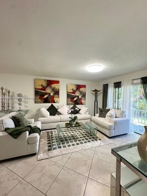 17901 Northwest 68th Avenue, Unit R101 Hialeah, FL 33015 - Photo 1 of 20 a living room with furniture and a rug