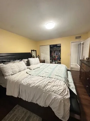 a large bed sitting in a bedroom and a flat tv screen