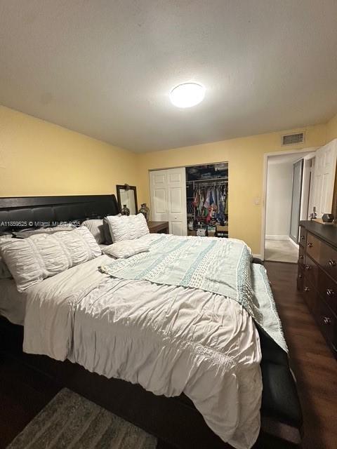 17901 Northwest 68th Avenue, Unit R101 Hialeah, FL 33015 - Photo 13 of 20 a large bed sitting in a bedroom and a flat tv screen