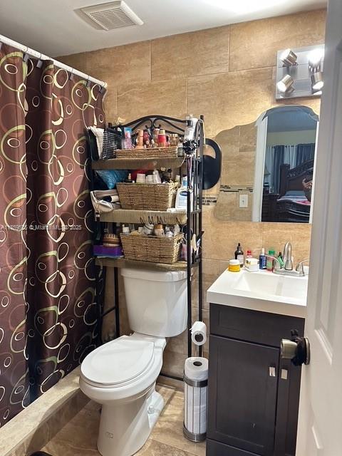 17901 Northwest 68th Avenue, Unit R101 Hialeah, FL 33015 - Photo 10 of 20 a bathroom with a toilet sink and mirror