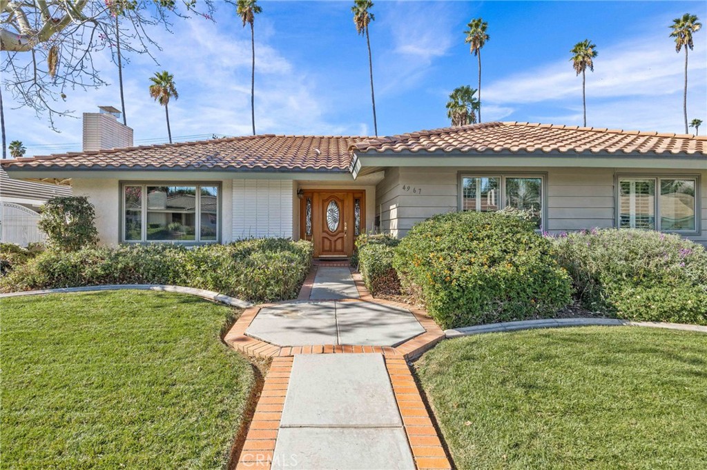 a front view of a house with a garden