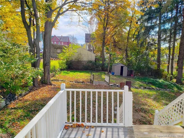 a view of a wooden deck and a backyard