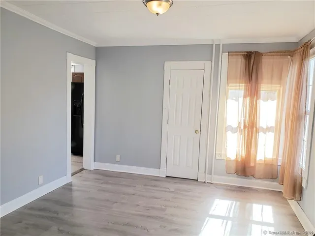 an empty room with windows and closet
