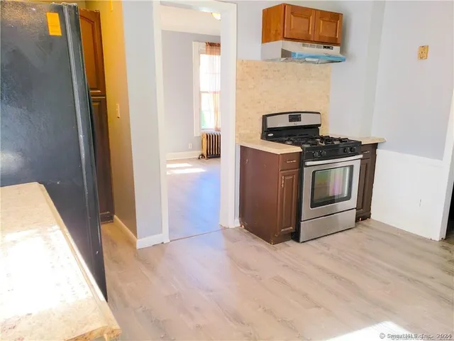 a kitchen with stainless steel appliances granite countertop a stove and a refrigerator