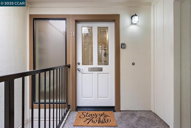 a view of a hallway with a wooden door