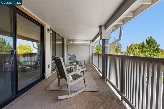 a view of balcony with furniture