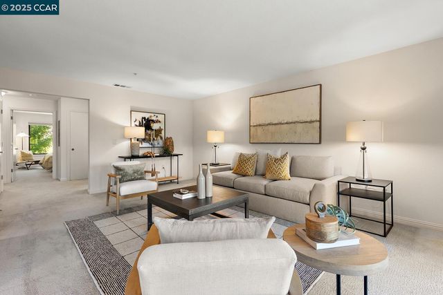a view of a dining room with furniture a chandelier and a large window