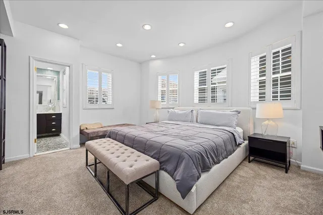 a spacious bedroom with a bed and a couch