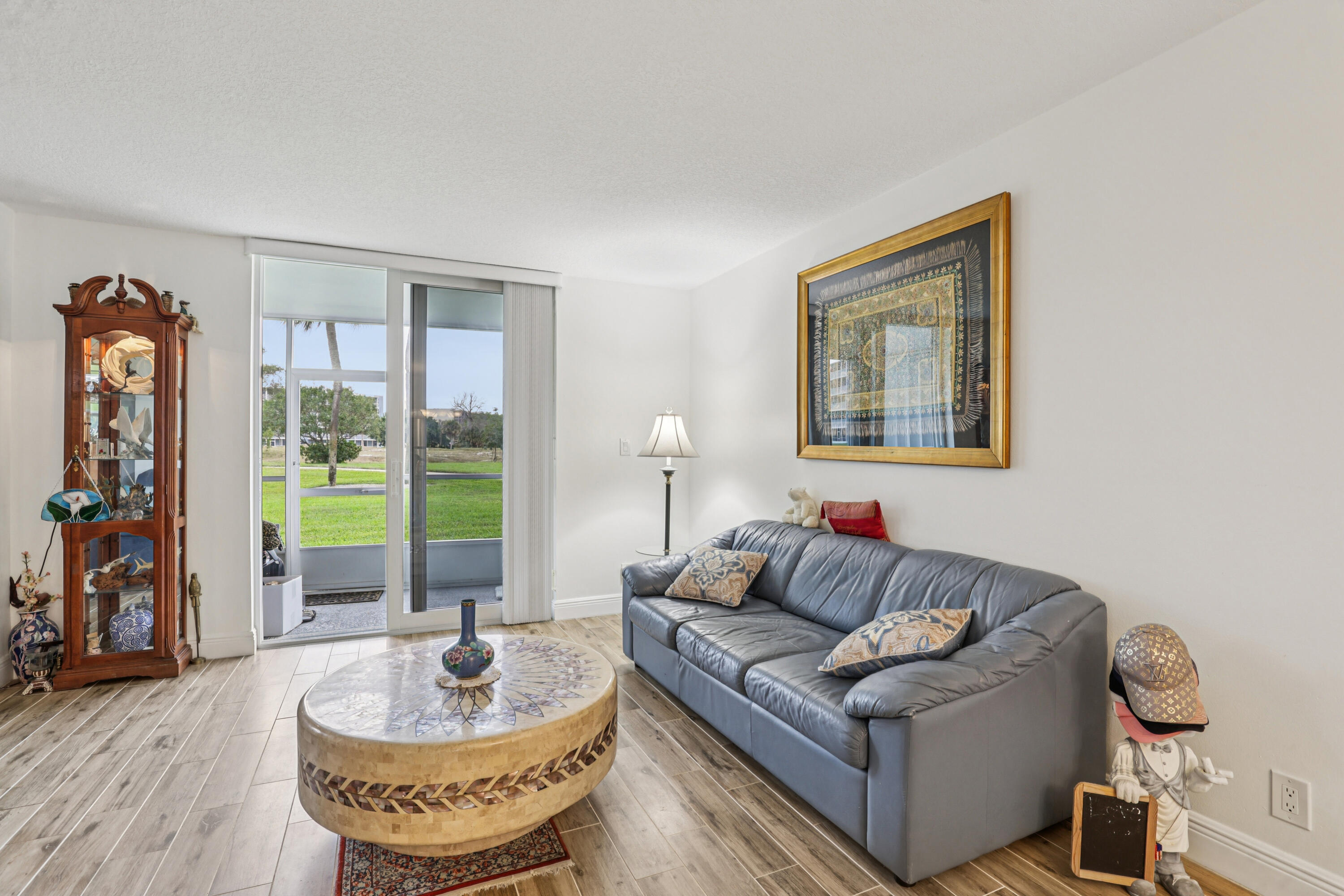 250 Northwest 67th Street, Unit 119 Boca Raton, FL 33487 - Photo 6 of 35 a living room with furniture and a large window