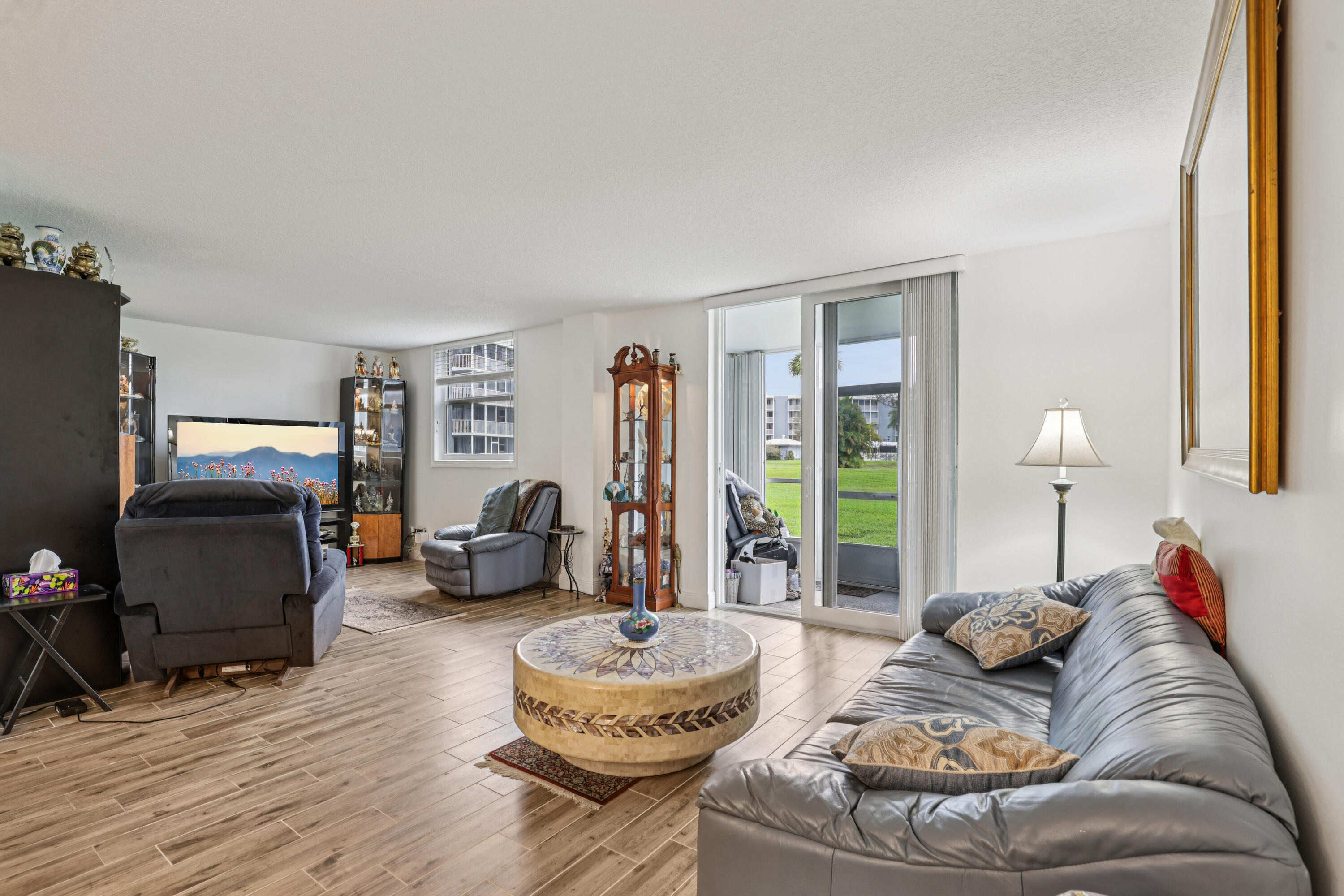 250 Northwest 67th Street, Unit 119 Boca Raton, FL 33487 - Photo 7 of 35 a living room with furniture and a large window