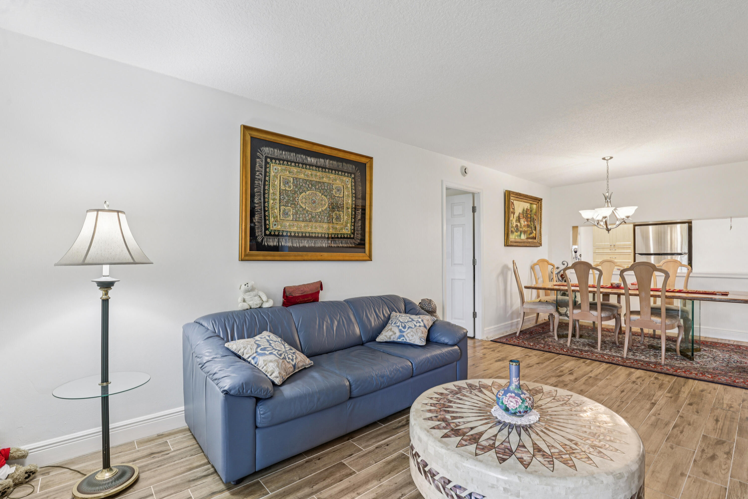 250 Northwest 67th Street, Unit 119 Boca Raton, FL 33487 - Photo 8 of 35 a living room with furniture and wooden floor