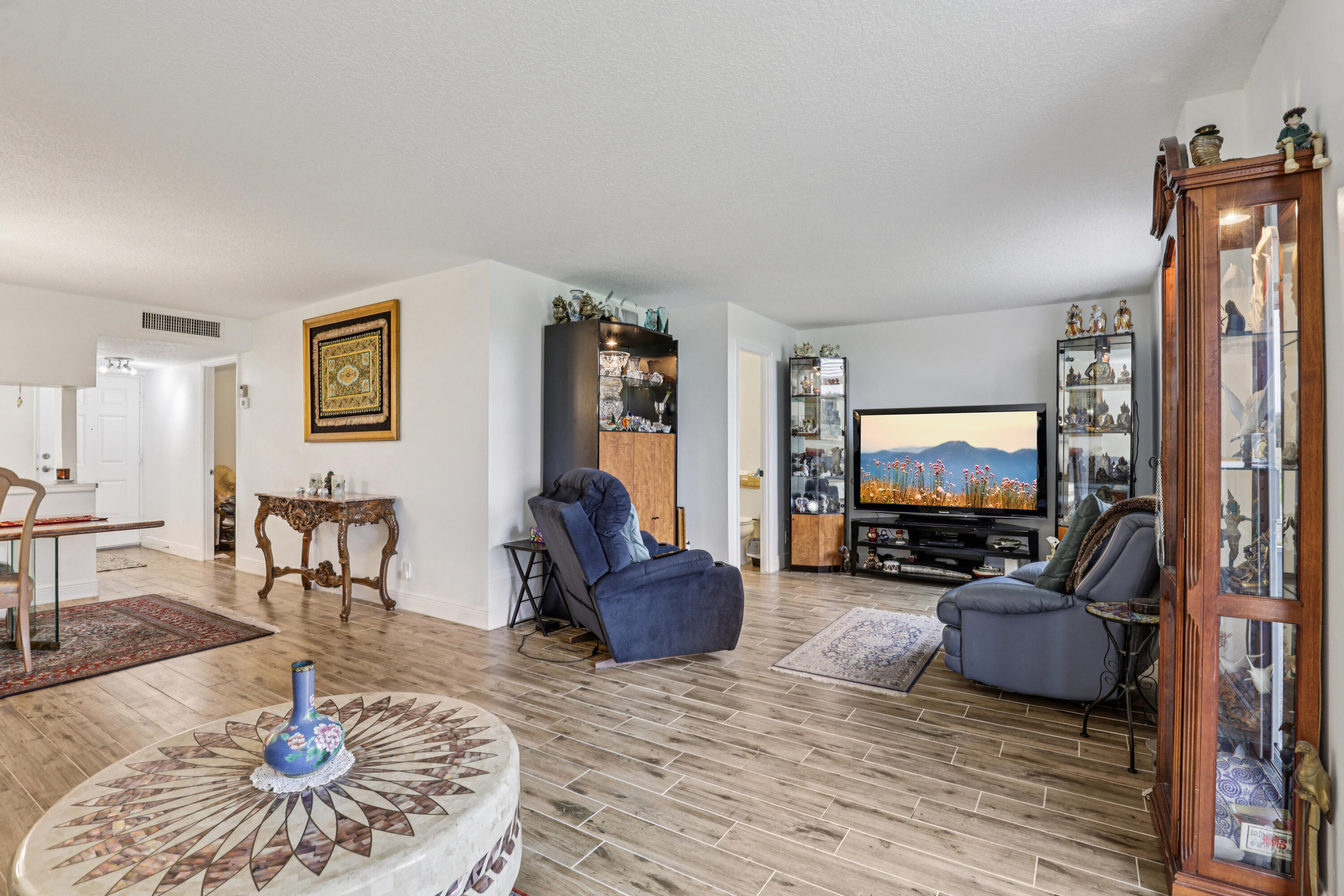 250 Northwest 67th Street, Unit 119 Boca Raton, FL 33487 - Photo 9 of 35 a living room with furniture and a flat screen tv
