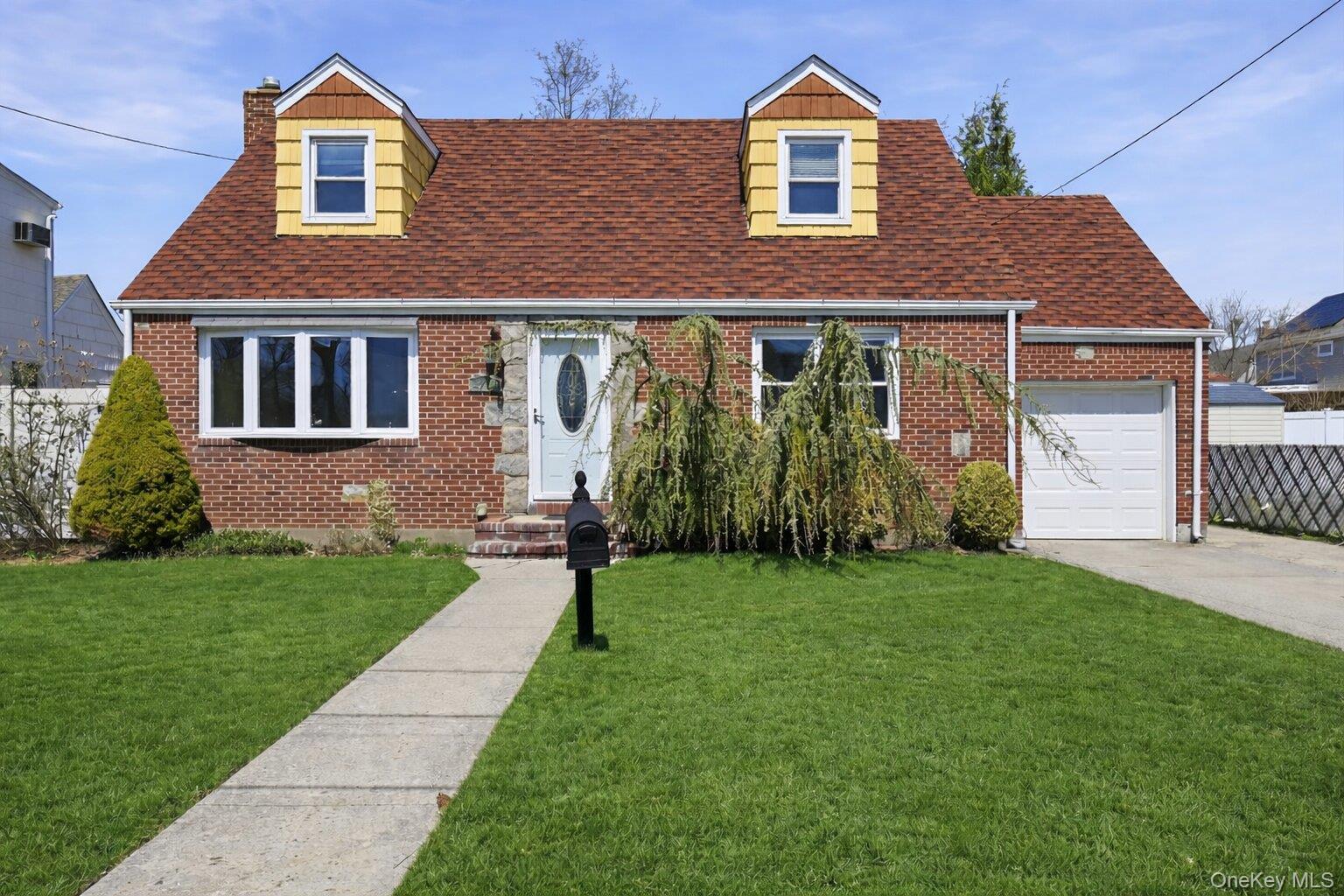 1719 William Street Merrick, NY 11566 - Photo 1 of 38 front view of a house with a yard