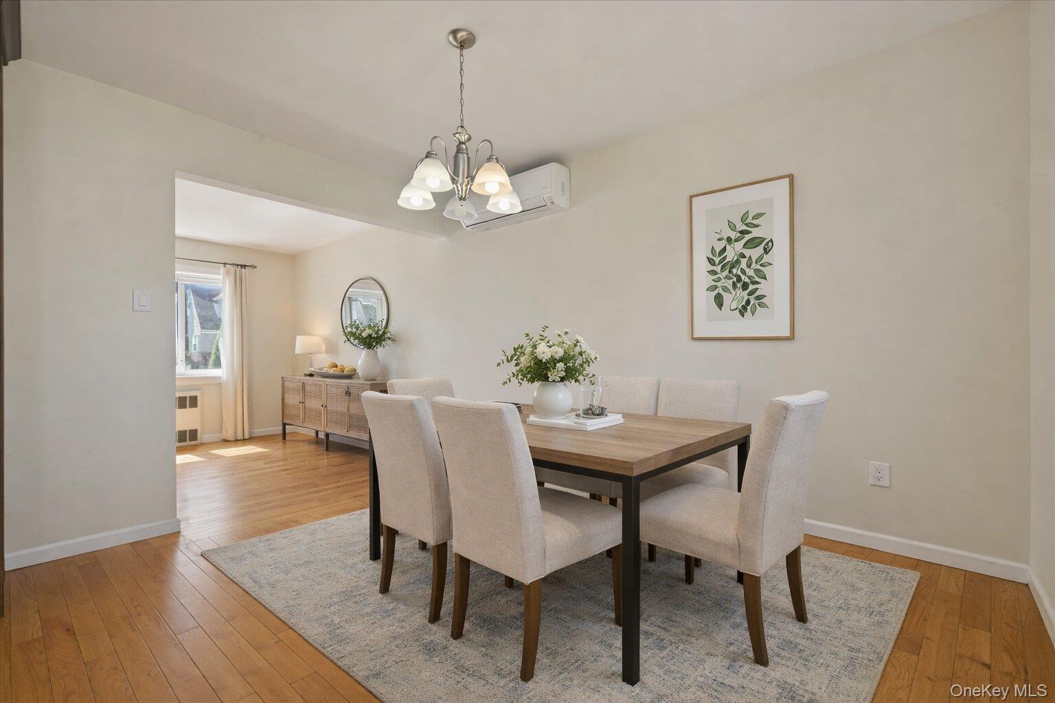 1719 William Street Merrick, NY 11566 - Photo 16 of 38 a view of a dining room with furniture wooden floor and a chandelier