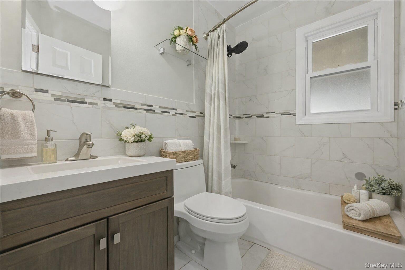 1719 William Street Merrick, NY 11566 - Photo 18 of 38 a bathroom with a sink a toilet and shower
