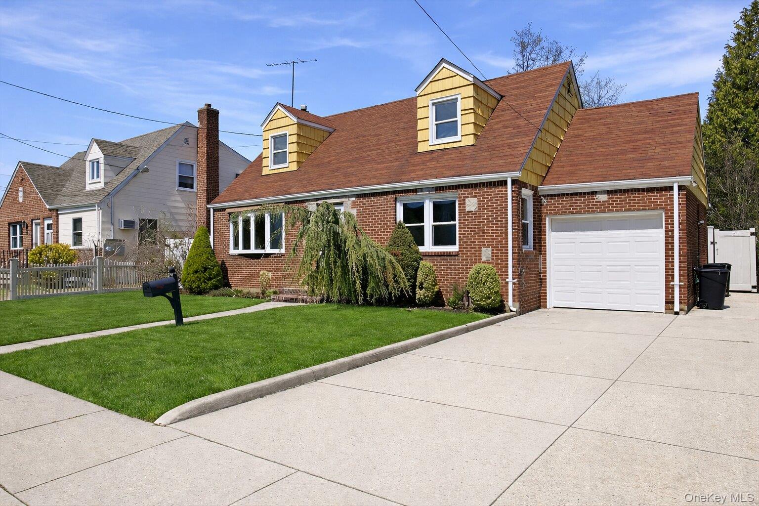1719 William Street Merrick, NY 11566 - Photo 2 of 38 a front view of house with yard and green space