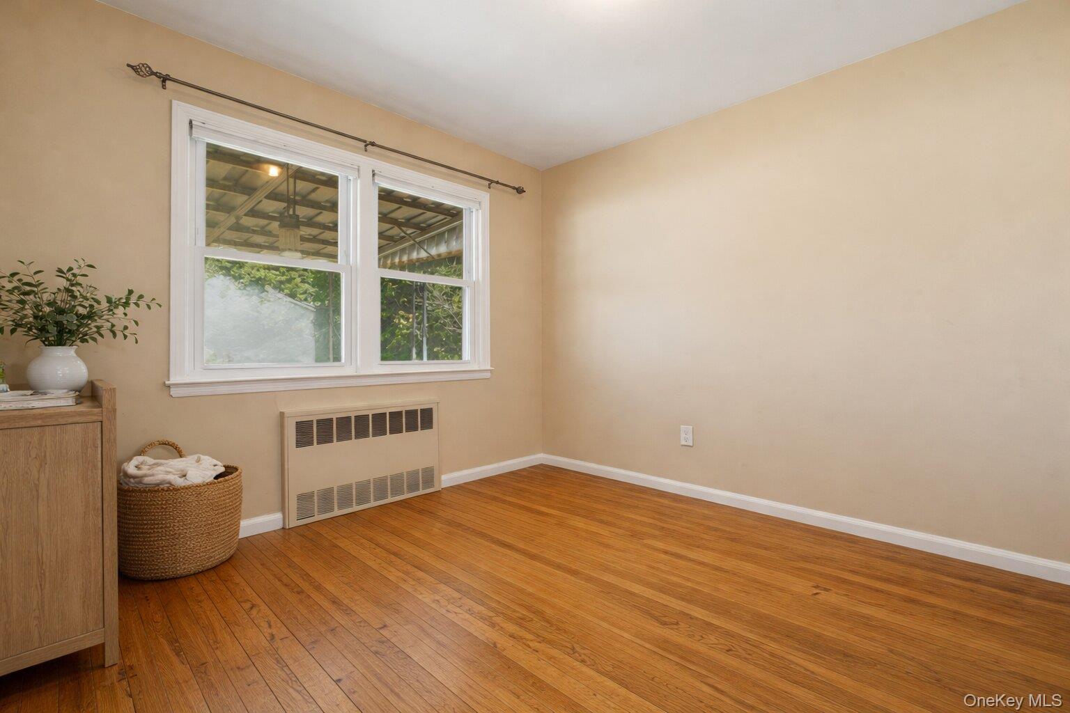 1719 William Street Merrick, NY 11566 - Photo 22 of 38 a view of an empty room with a window and wooden floor