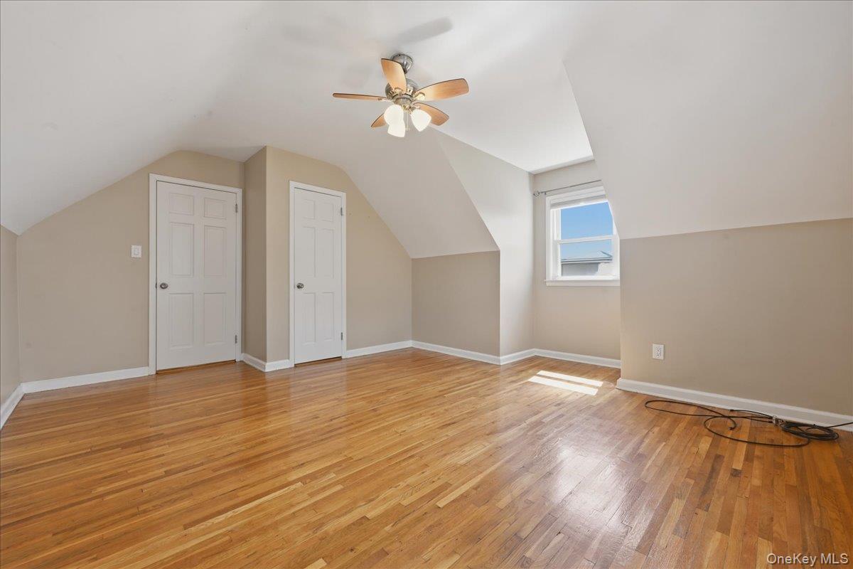 1719 William Street Merrick, NY 11566 - Photo 25 of 38 a view of an empty room with wooden floor and a ceiling fan
