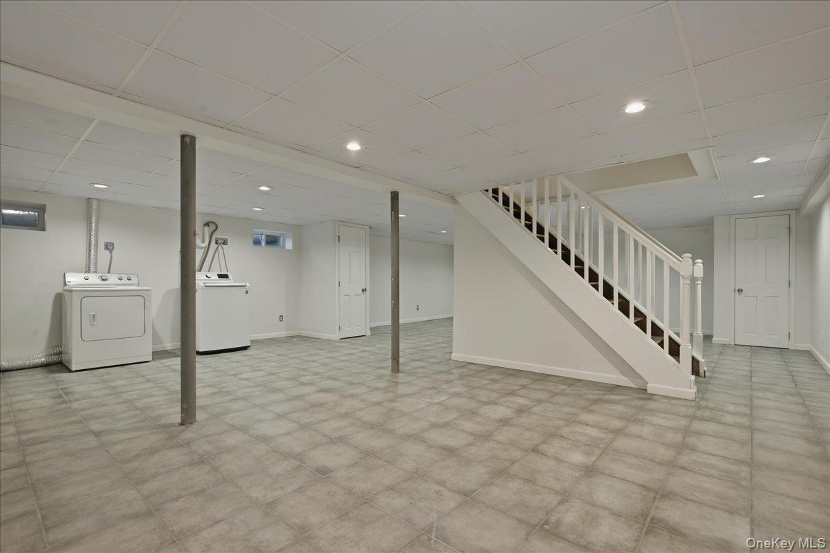 1719 William Street Merrick, NY 11566 - Photo 30 of 38 a view of a big room with staircase and white walls