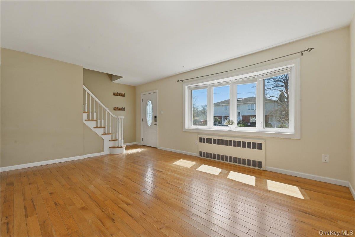 1719 William Street Merrick, NY 11566 - Photo 10 of 38 a view of an empty room with wooden floor and windows
