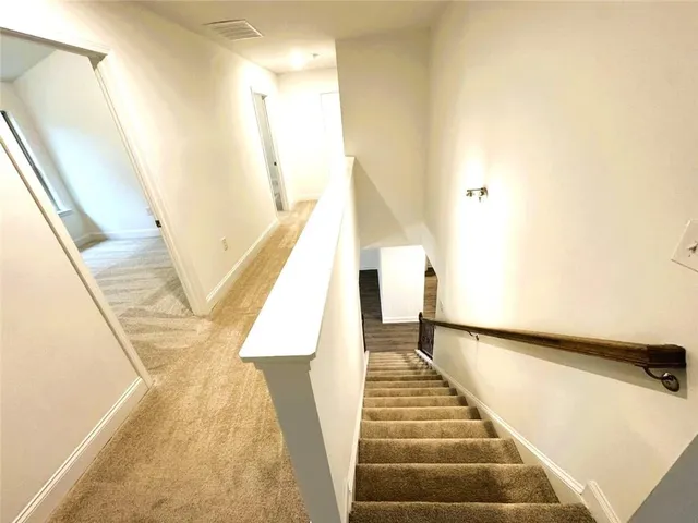 a view of entryway with wooden floor and stairs