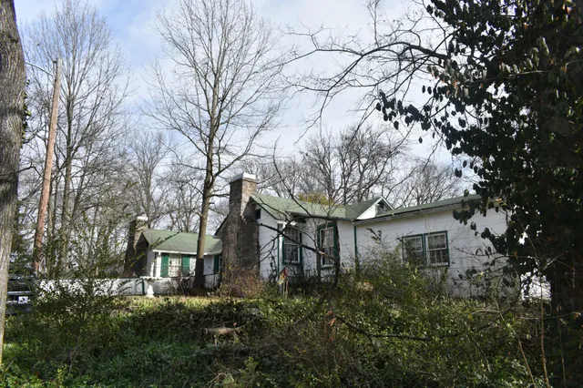 a view of a house with large trees