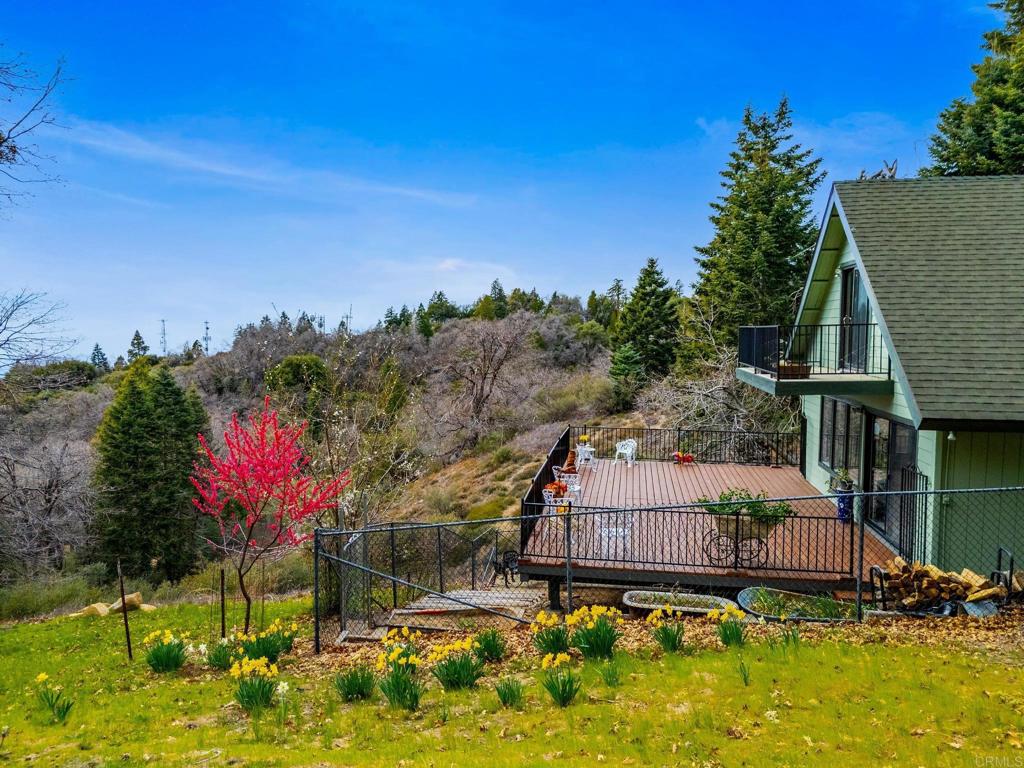 a backyard of a house with yard table and chairs