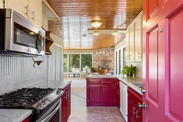 a kitchen with stove and cabinets